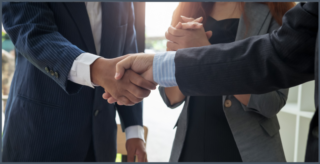 photo of two people in business professional attire, shaking hands